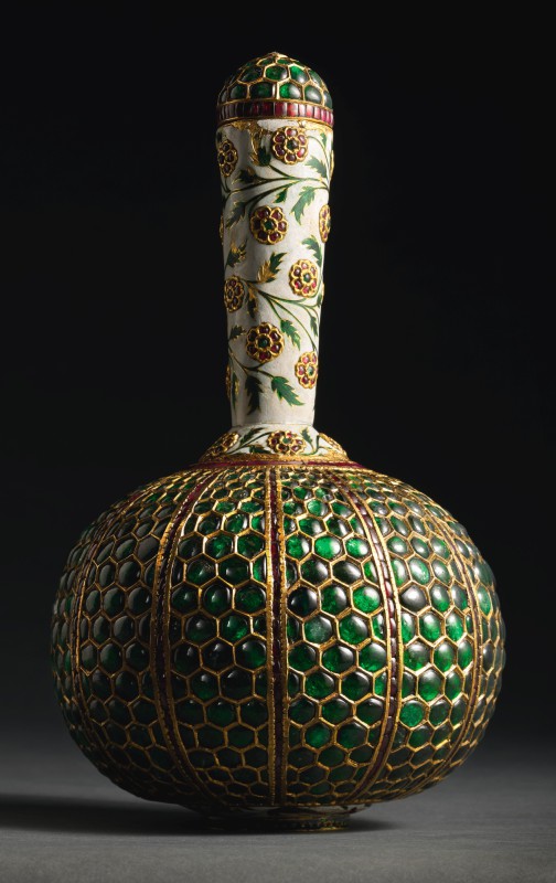 Lot 456. A Mughal gem-set and enamelled gold flask (surahi), North India, late 17th/early 18th century. Set with over six-hundred emeralds, this flask (surahi) is striking for its exuberant use of gemstones offset by the white-ground enamel. Provenance: Ex-collection Nizam of Hyderabad, gifted to the family of the current owners, 1930s, thence by descent. Lot 456. A Mughal gem-set and enamelled gold flask (surahi), North India, late 17th/early 18th century. Set with over six-hundred emeralds, this flask (surahi) is striking for its exuberant use of gemstones offset by the white-ground enamel. Provenance: Ex-collection Nizam of Hyderabad, gifted to the family of the current owners, 1930s, thence by descent.