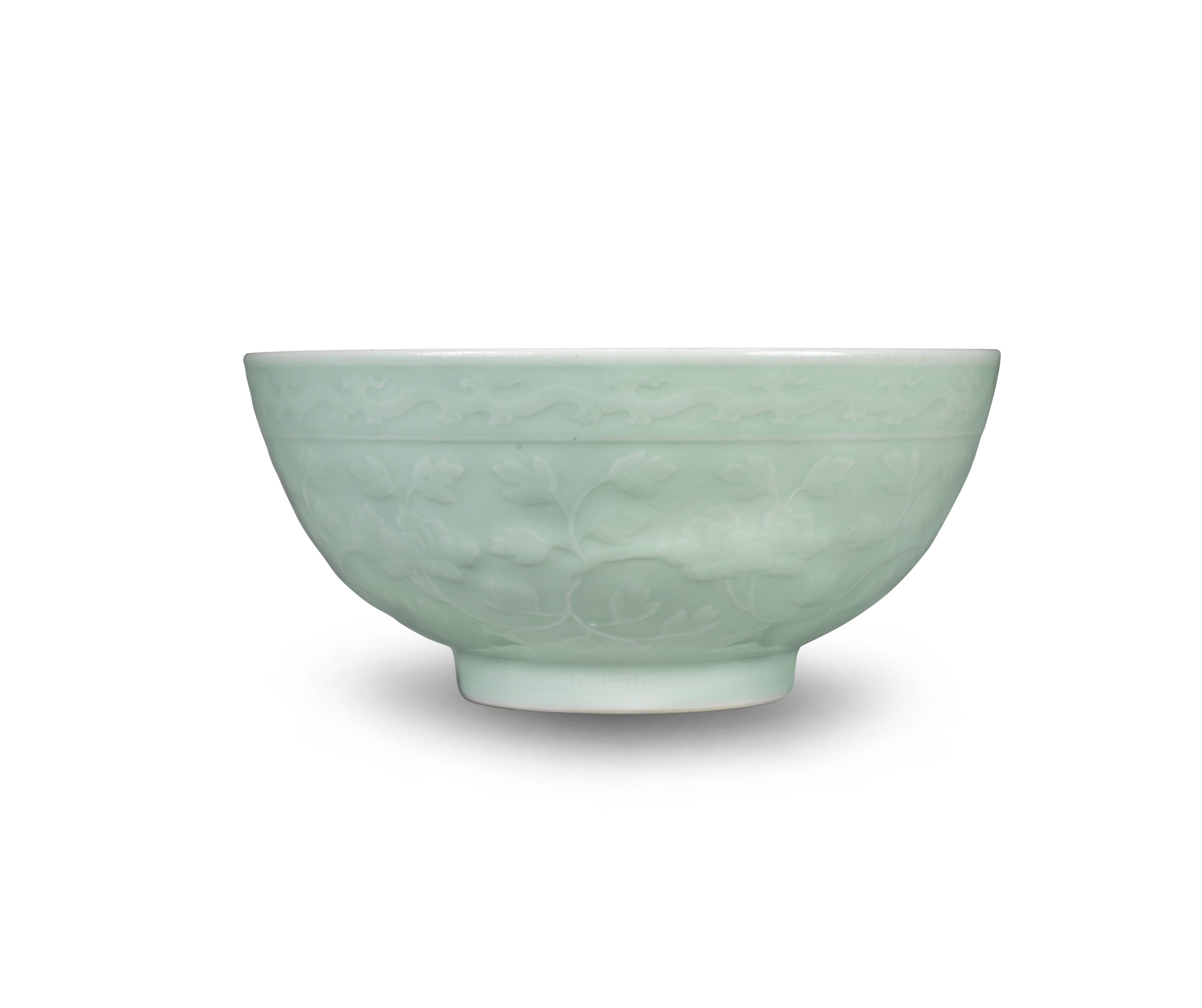 A FINE AND RARE CARVED CELADON-GLAZED 'PEONY' BOWL Yongzheng seal mark and of the period
