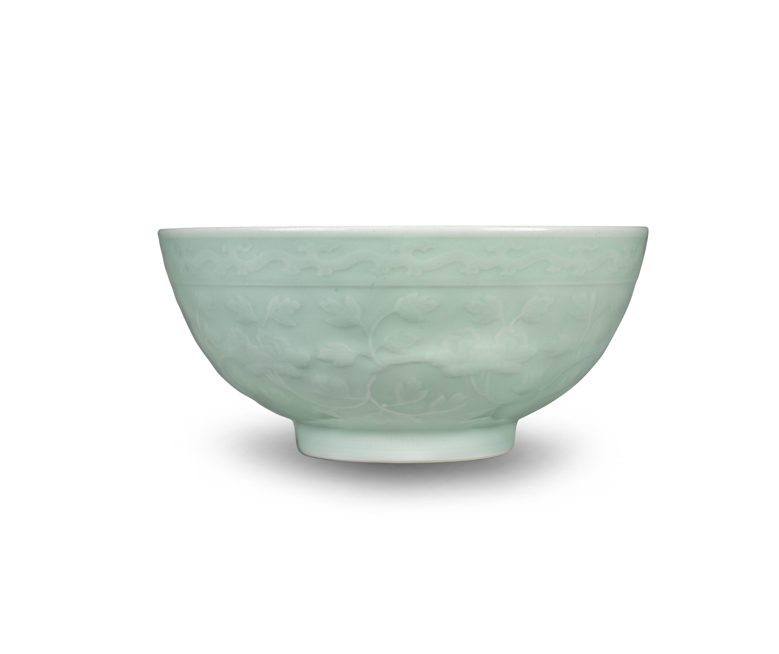 A FINE AND RARE CARVED CELADON-GLAZED 'PEONY' BOWL Yongzheng seal mark and of the period A FINE AND RARE CARVED CELADON-GLAZED 'PEONY' BOWL Yongzheng seal mark and of the period
