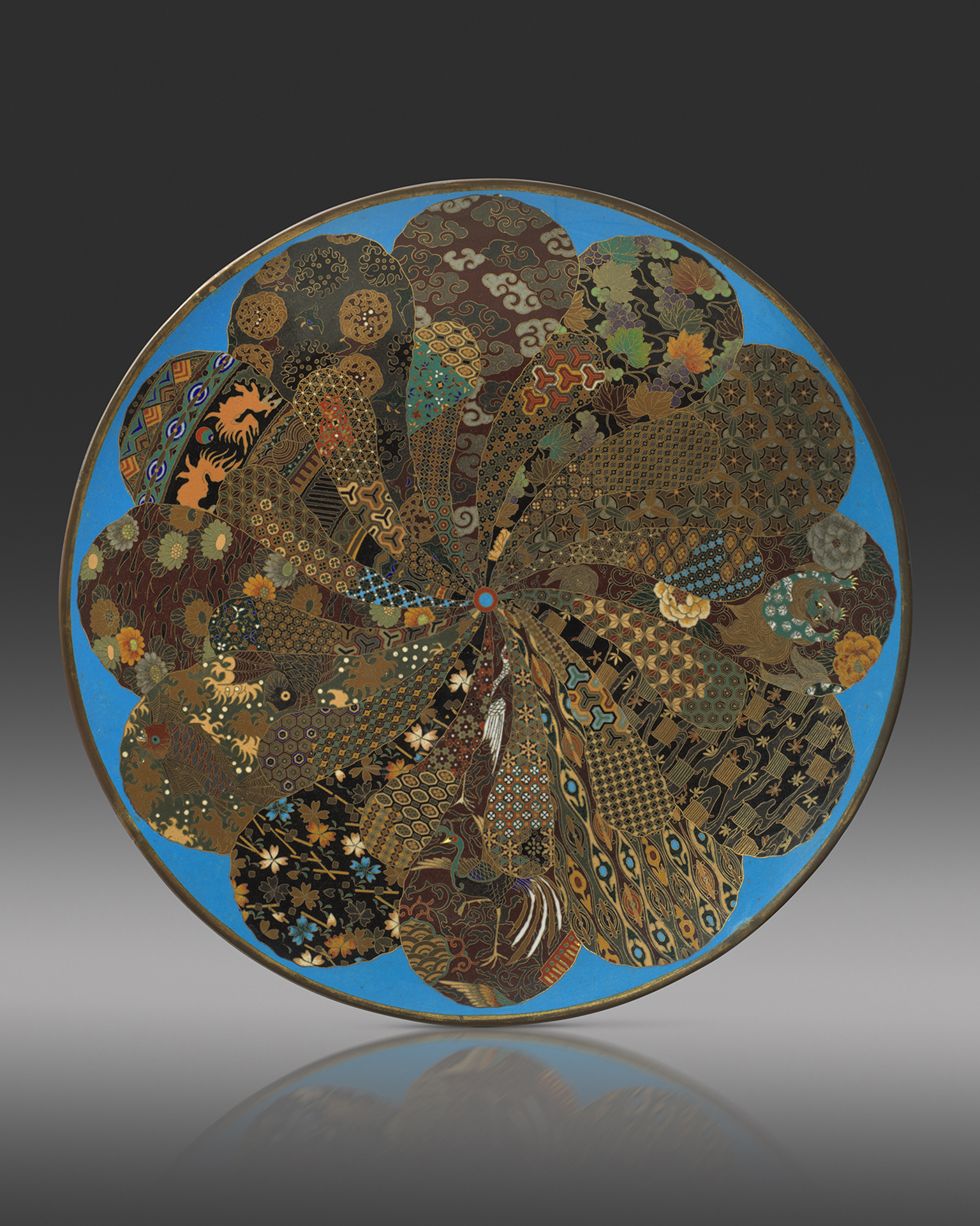 A cloisonne enamel dish worked in gilt wire with a radiating petal-like design of natural and geometric motifs, 45.5cm, Meiji Period Circa 1890 A cloisonne enamel dish worked in gilt wire with a radiating petal-like design of natural and geometric motifs, 45.5cm, Meiji Period Circa 1890