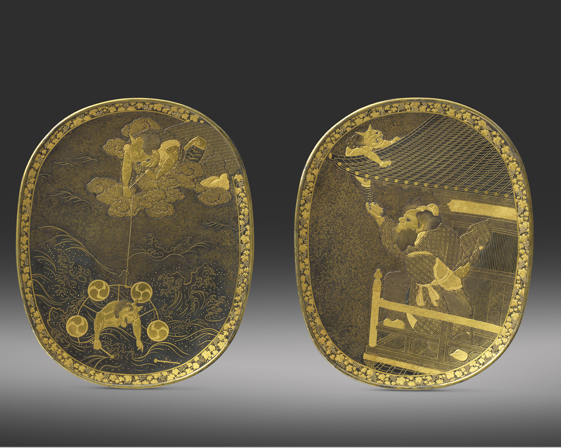A pair of unusual inlaid iron plaques with Raiden (The Thunder God) in clouds lowering his drums on a fishing line towards an oni clutching a drumstick having lost the other in turbulent waves, the other with Shoki on a balcony clutching an oni by its ankle as it attempts to escape on a roof, with various silver details, within fruiting vine borders, Both signed Komai Sei, one in silver the other in gold, Meiji Period Circa 1875 A pair of unusual inlaid iron plaques with Raiden (The Thunder God) in clouds lowering his drums on a fishing line towards an oni clutching a drumstick having lost the other in turbulent waves, the other with Shoki on a balcony clutching an oni by its ankle as it attempts to escape on a roof, with various silver details, within fruiting vine borders, Both signed Komai Sei, one in silver the other in gold, Meiji Period Circa 1875