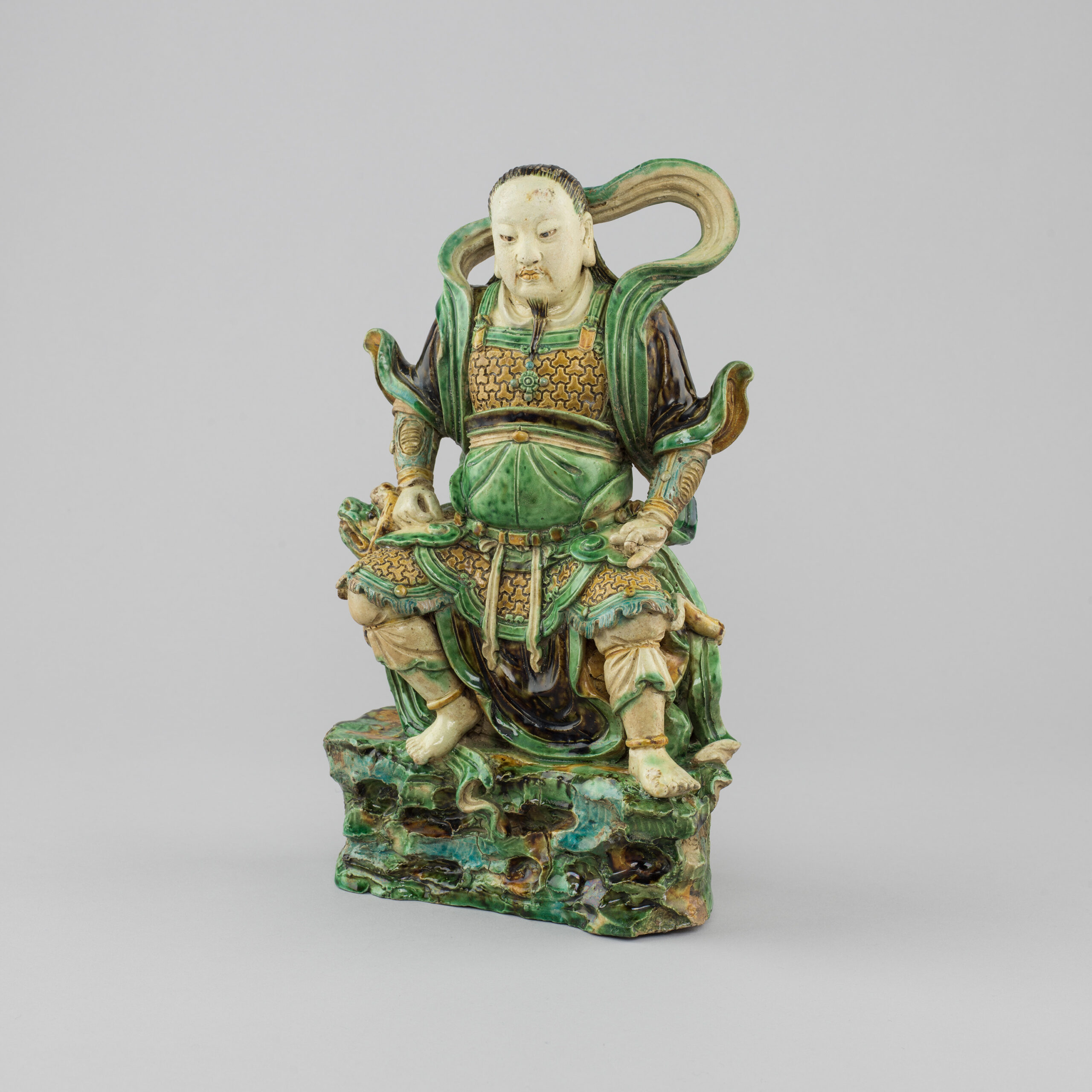 Chinese famille verte biscuit porcelain model of the seated god of the North, Zhenwu.
