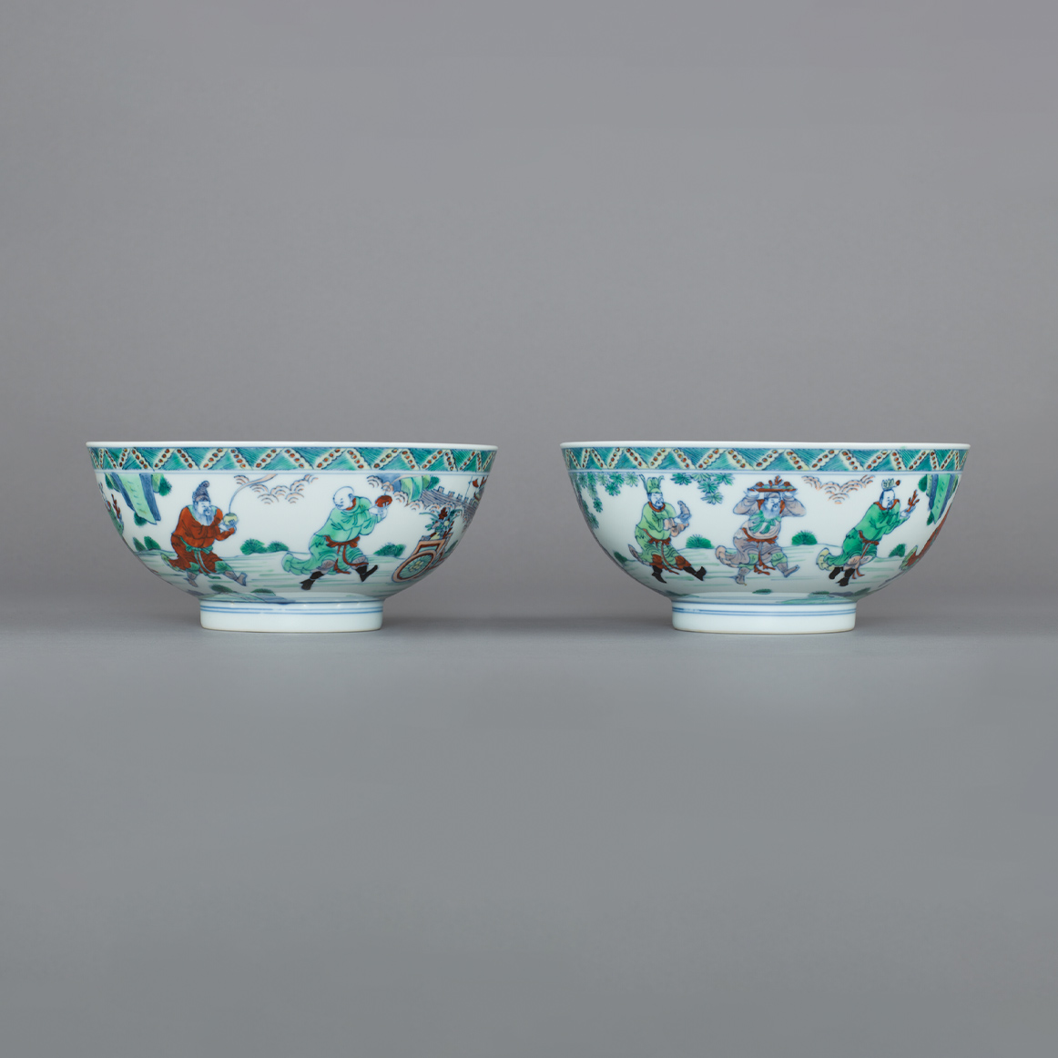 Pair of Chinese Imperial porcelain doucai bowls, each painted with five tribute bearers Pair of Chinese Imperial porcelain doucai bowls, each painted with five tribute bearers