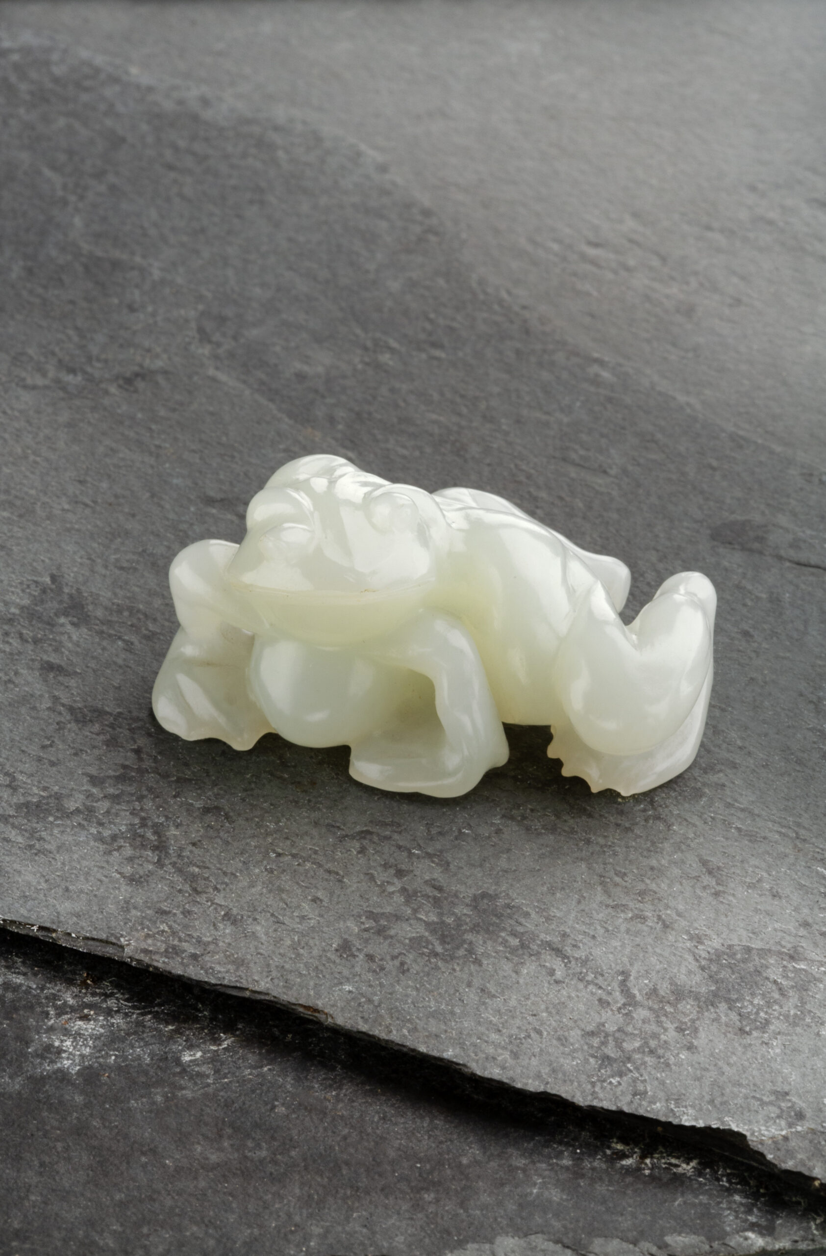 A WHITE JADE CARVED TOAD | Qing Dynasty 18th Century | Length: 5.7 cm, 2 1⁄4 ̋ Inches A WHITE JADE CARVED TOAD | Qing Dynasty 18th Century | Length: 5.7 cm, 2 1⁄4 ̋ Inches