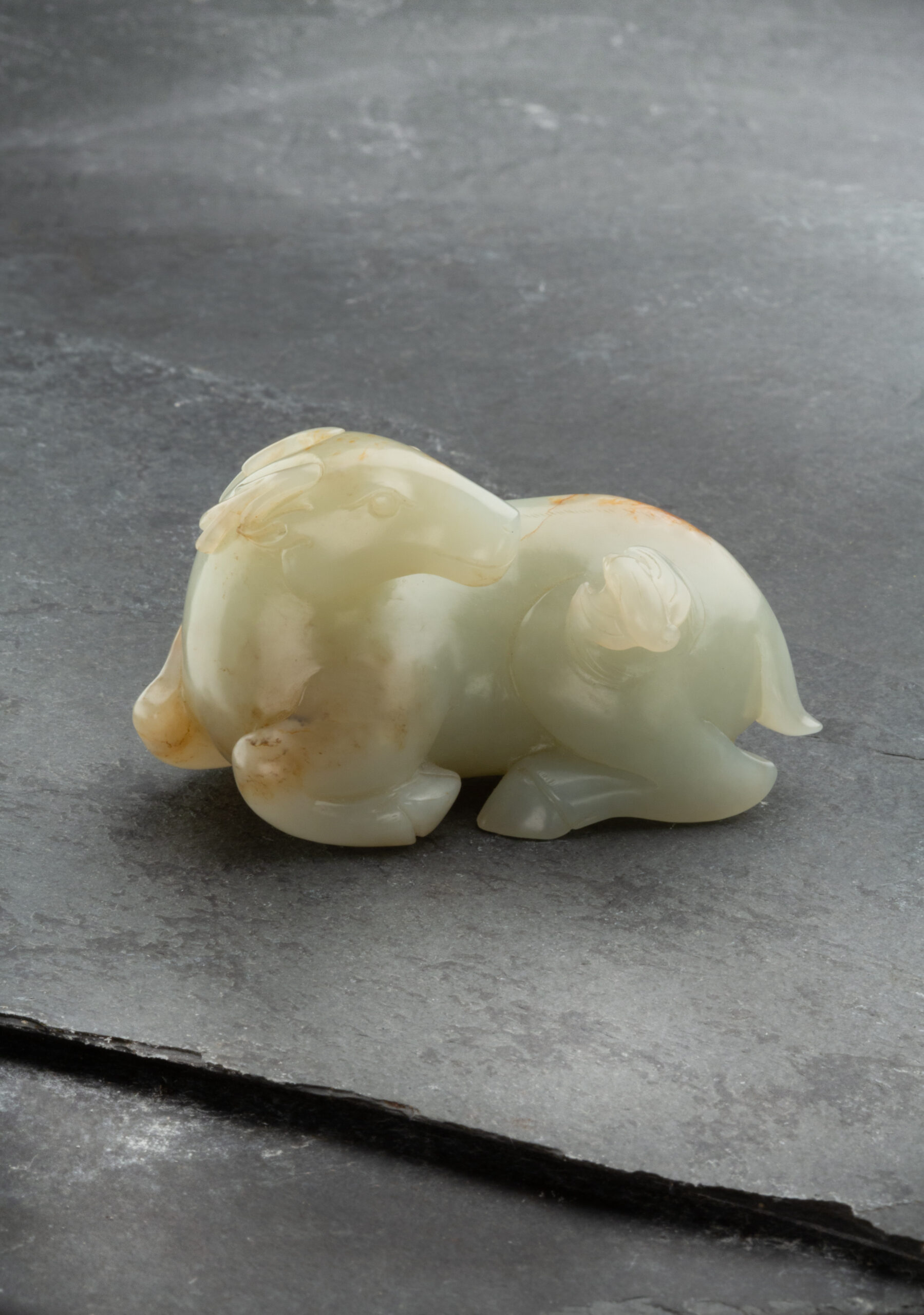 A PALE CELADON AND RUSSET CARVED JADE DEER AND BAT GROUP | Ming/Qing Dynasty, 17th century | Length: 7.5 cm, 3 ̋ Inches A PALE CELADON AND RUSSET CARVED JADE DEER AND BAT GROUP | Ming/Qing Dynasty, 17th century | Length: 7.5 cm, 3 ̋ Inches