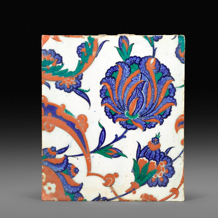 Iznik pottery tile, Turkey, 1570-80, Painted in underglaze blue, viridian green and bole red on a white ground, with large composite flowers and arabesques forming a spiral, 25.6 by 22 cm Iznik pottery tile, Turkey, 1570-80, Painted in underglaze blue, viridian green and bole red on a white ground, with large composite flowers and arabesques forming a spiral, 25.6 by 22 cm