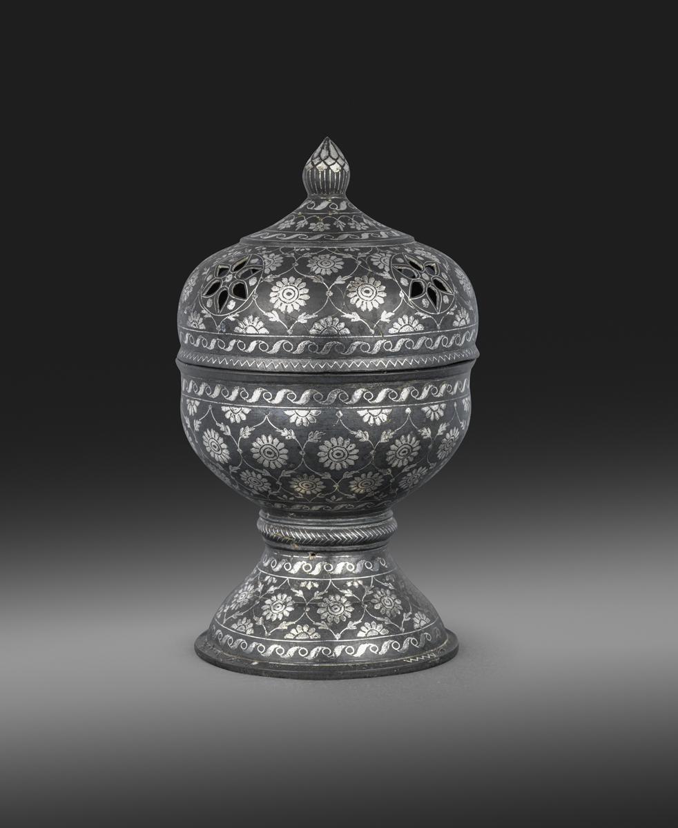 A ‘Bidri’ silver-inlaid metal incense-burner Deccan, eighteenth century metal alloy with silver, 23.3 cm., 9 1/4 in. A ‘Bidri’ silver-inlaid metal incense-burner Deccan, eighteenth century metal alloy with silver, 23.3 cm., 9 1/4 in.