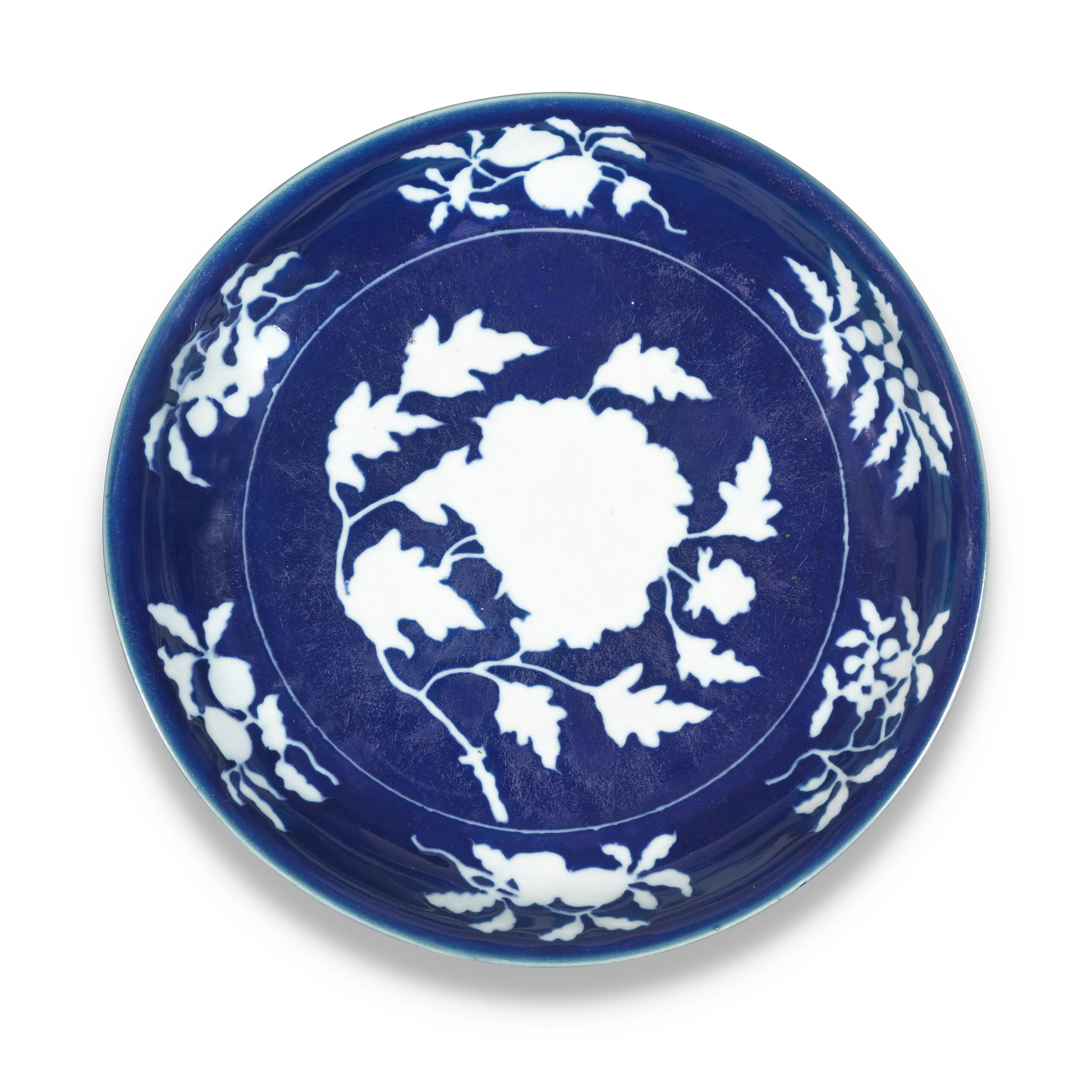 AN EXCEPTIONALLY RARE LARGE BLUE AND WHITE RESERVE-DECORATED ‹PEONY› DISH, Xuande six-character mark in a line and of the period