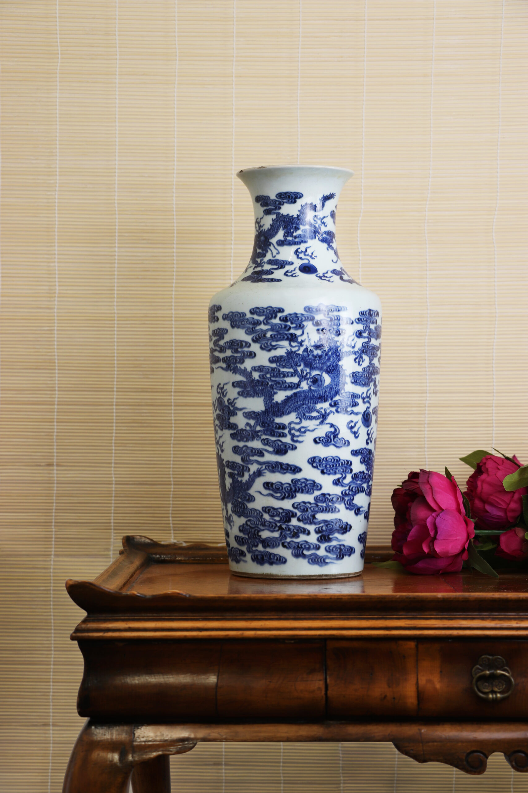 A Chinese blue and white vase, of rouleau form, painted with dragons chasing flaming pearls among clouds, 18th century